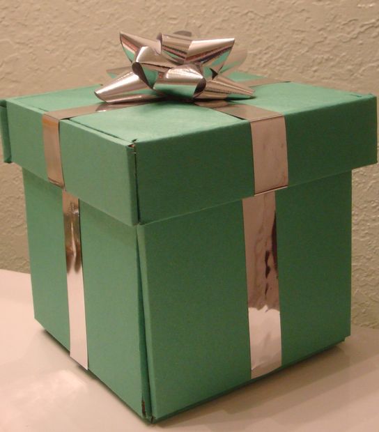 Handmade green cardboard gift box with silver ribbon decoration