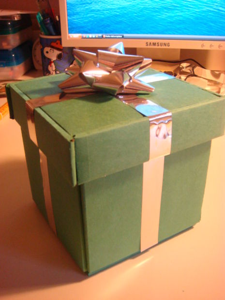 Completed cardboard gift box with bow on top