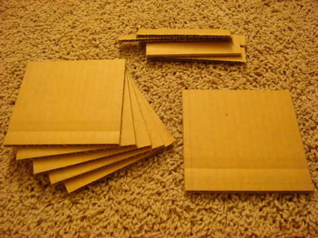 Multiple square cardboard pieces arranged for box making