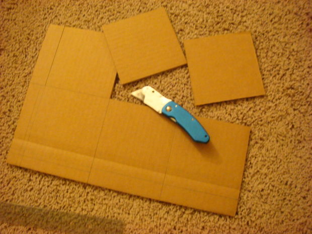 Cardboard template being cut using a cutter