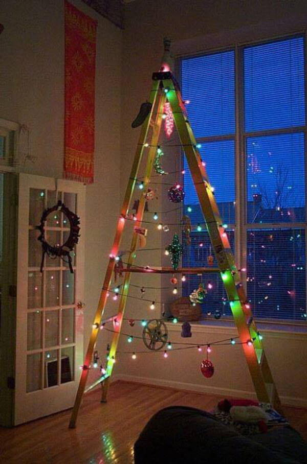 Christmas tree with two ladders and lights