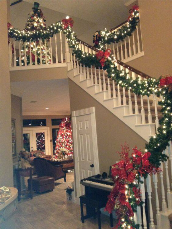 Staircase Decoration with lights, Shiny ribbons, and leaves for Christmas