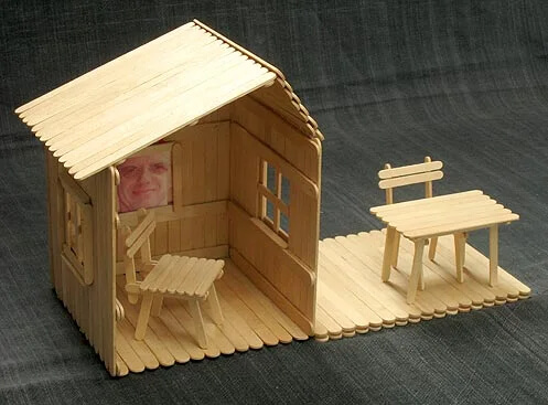 Mini popsicle stick house with table and chair