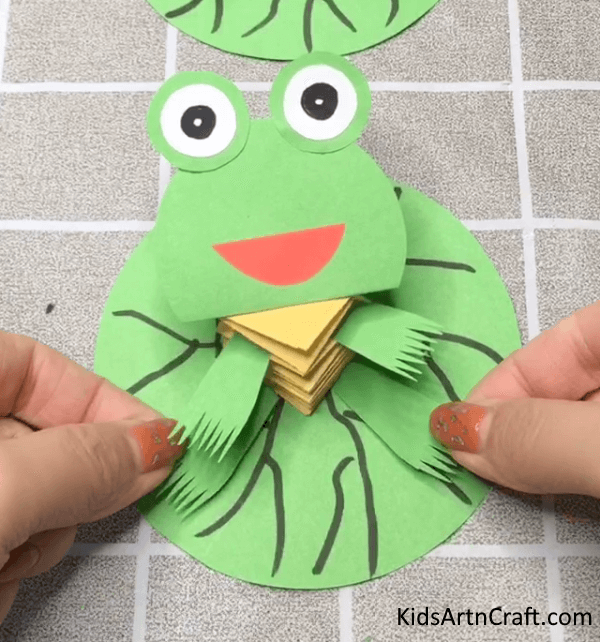 Sticking Paper Legs Of Slinky Frog Craft Tutorial