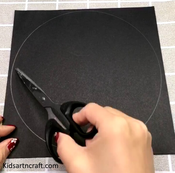 Taking A black Paper & Cutting Circles To Make Mouse Craft For Kindergarteners