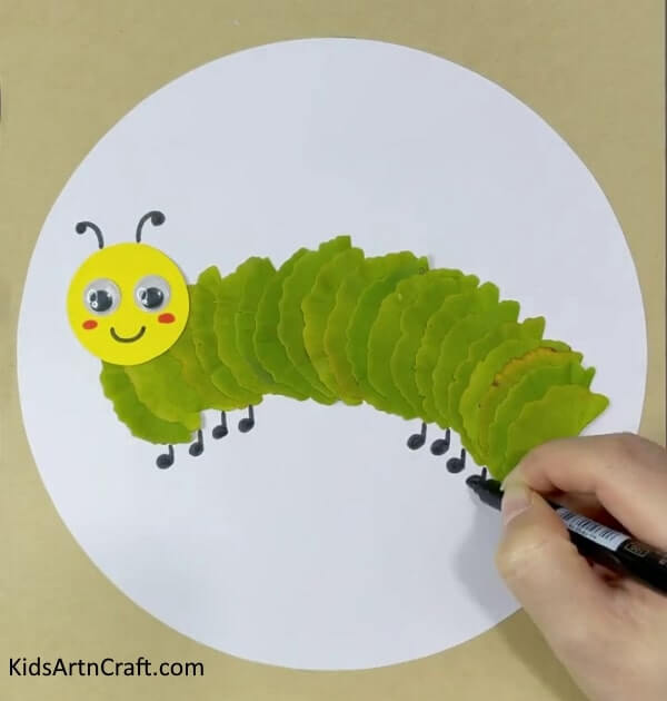 A marvelous caterpillar and sun artwork composed of leaves, paper, and googly eyes - Lovely Caterpillar And Sun Craft With Leaves