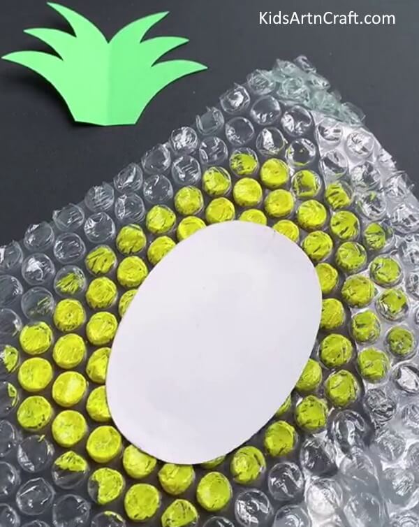 Placing The White Sheet On Bubble Wrap - A Guide to Making a Bubble Wrap Artwork of a Pineapple