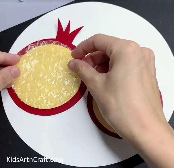 Pasting Bubble Wrap On Yellow  - A Fun & Creative Bubble Wrap Activity For Kids - Pomegranate Art 