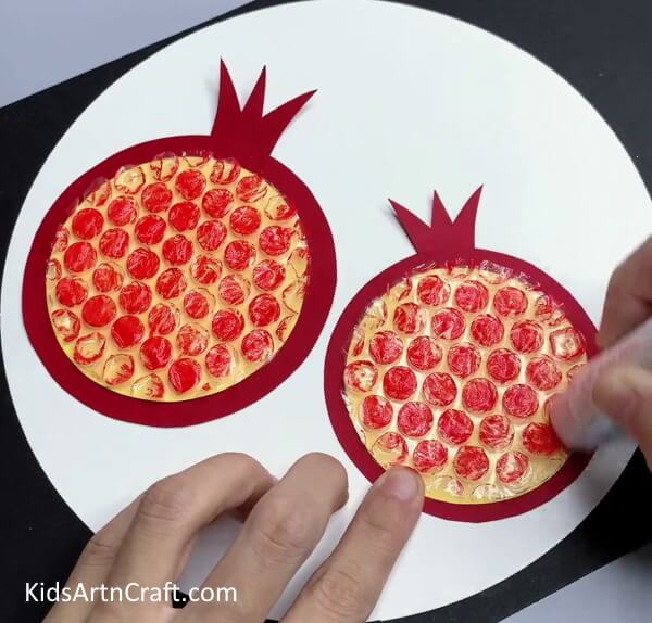 Coloring Red On Bubble Wrap - Kids Can Make Pomegranate Art Utilizing Bubble Wrap 