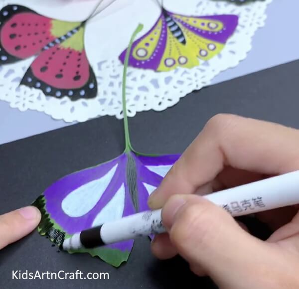 Paint The Area Around The Wings With Different Colours-Working on butterfly leaf art with the little ones in the house
