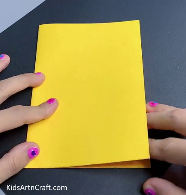 Folding Yellow Paper In Half - Here's How You Can Easily Create a Balloon Chicken Craft