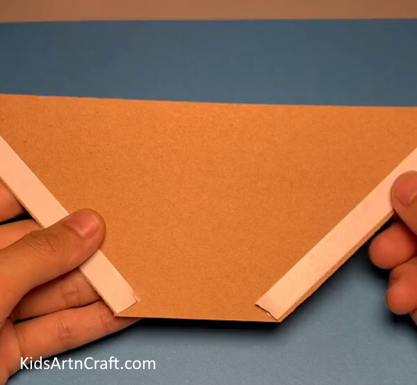 Applying Double Side Tape On Paper Nest - Crafting a Home for a Bird With Paper 