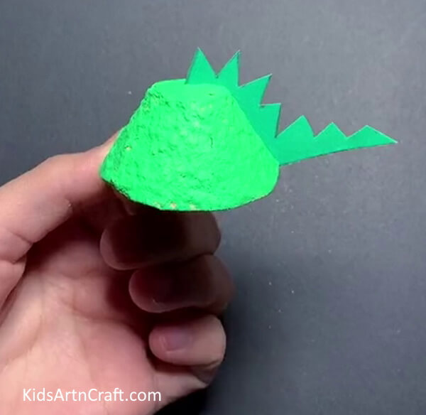 Cutting Out Tail- Step-by-step instructions for making egg carton dinosaurs for kids. 