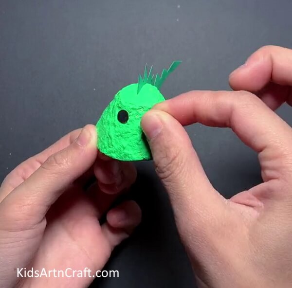 Making Eyes- Creating dinosaurs from egg cartons - a fun activity for kids. 