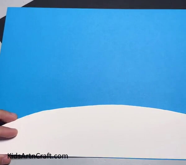 Pasting White Land on Blue Paper - Making a Creative Foam Netting Artwork in the Comfort of Your Home