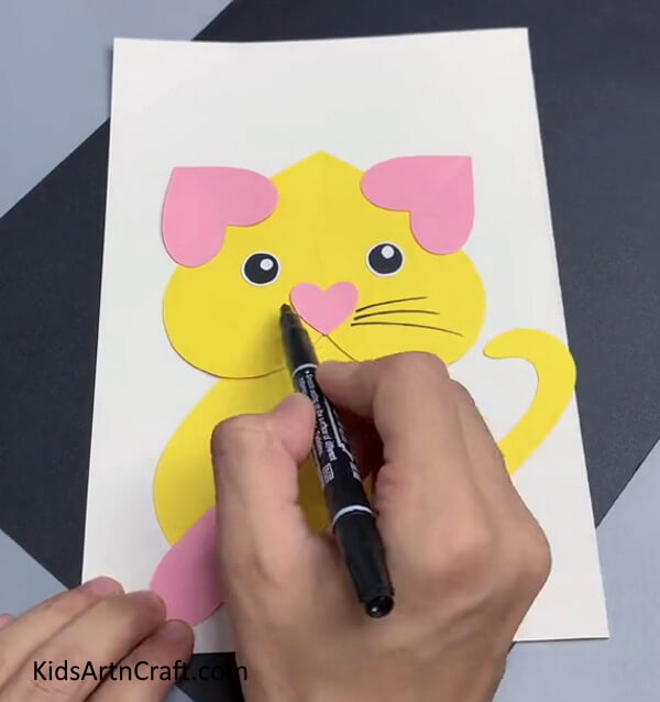 Drawing Whiskers Using a Black Marker - Have Fun Crafting a Heart-Shaped Cat for Valentine's Day