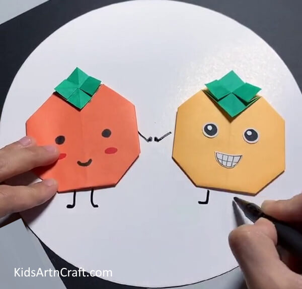 Add Hands And Legs-Using craft paper to create origami fruit for youngsters. 