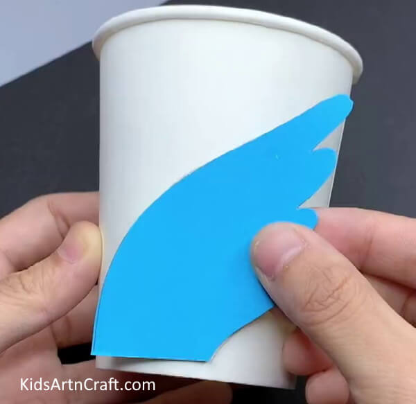 Placing Wing Shape on Paper Cup - DIY Paper Cup Swan Project For Children