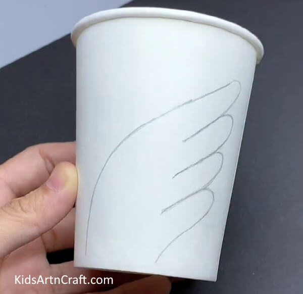 Tracing Wing With Pencil - Step-by-Step Guide to Making a Swan Out of Recycled Paper Cups