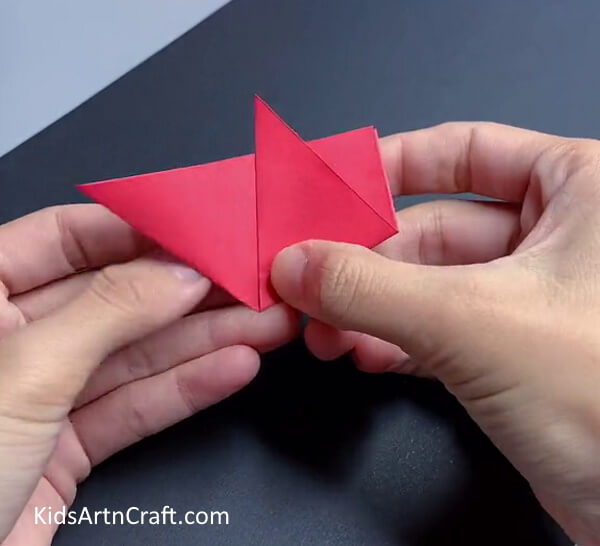 Folding One End Of  the Triangle - Crafting Paper Flowers with Kids: An Easy Tutorial