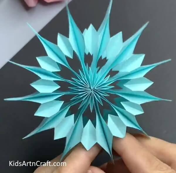 Pasting The Ends Together- Follow this guide to make your own hanging paper snowflake decoration.