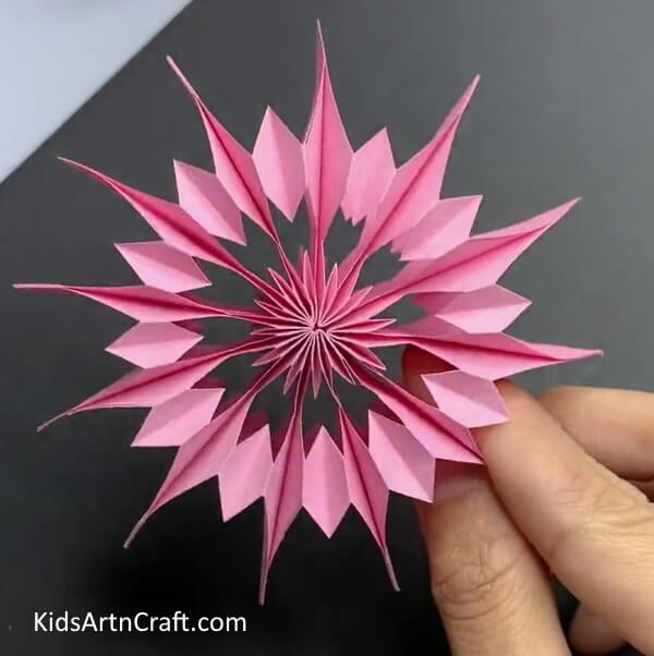 Making A Pink Snowflake-Learn how to craft a wall-mounted paper snowflake.