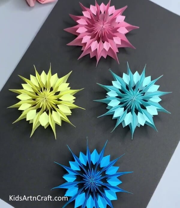 Making More Colorful Snowflakes- Create a stunning paper snowflake wall hanging with this tutorial.