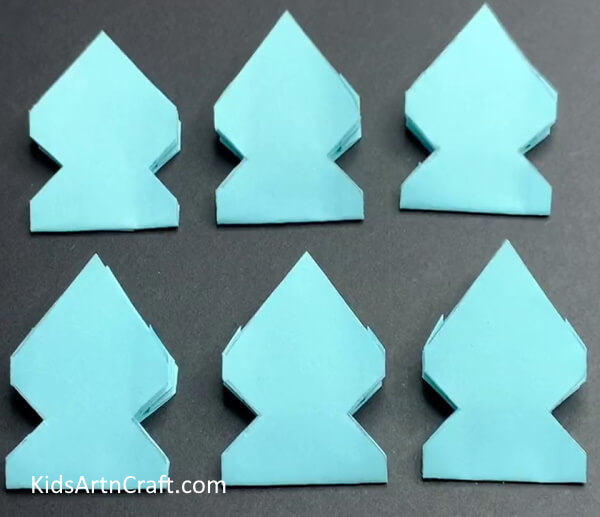 Making More Snowflake Pieces- How to make a paper snowflake wall hanging. 