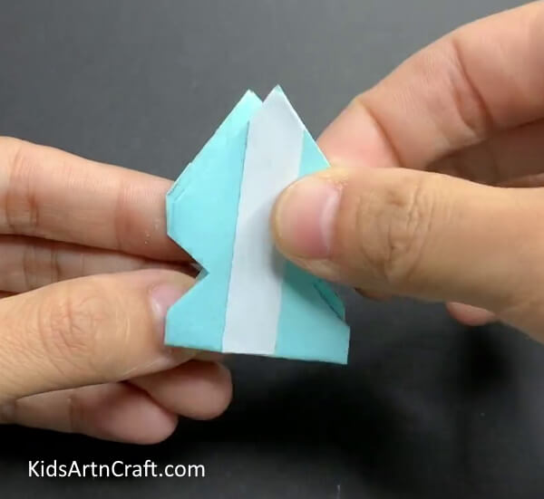 Applying Double-sided Tape To The Piece- Learn to make a paper snowflake wall hanging. 