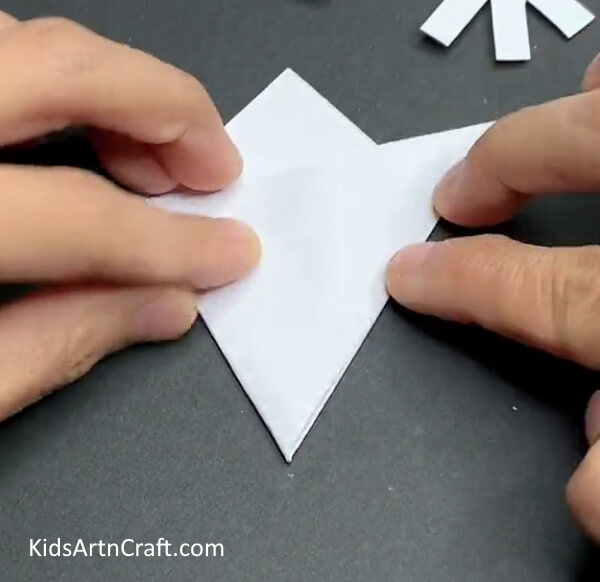 Repeat The Same Step For The Other Side As Well-Creating Paper Snowflakes - A Step-by-Step Guide for Little Ones 