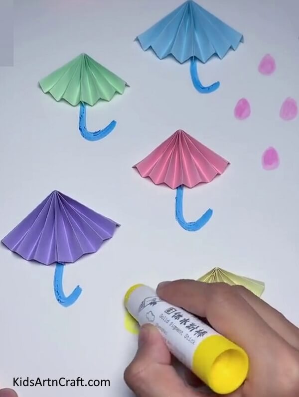 Draw Droplets Using Different Colours- Master the art of making a Paper Umbrella with this easy tutorial!