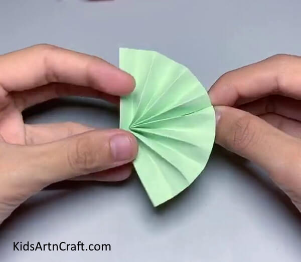 Secure The Mid Portion Using The Adhesive- Make a Paper Umbrella using this user-friendly tutorial! 