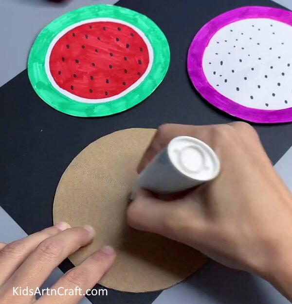 Applying Glue On Cardboard Circle - Enchanting Paper Watermelon Activity For Pre-K Kids
