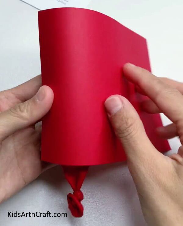Wrapping Red Paper - Have a Blast Crafting a Party Popper with Your Kids