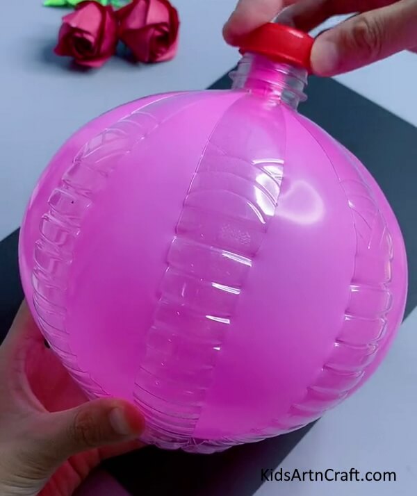 Cover the balloon opening with a bottle cap. Easy Bunny Craft Using Recycled Plastic Bottles tutorial artwork for Kids