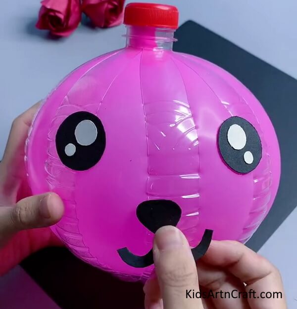 Adding a nose and a smile. Tutorial for making a Easy Bunny Craft Using Recycled Plastic Bottles for Kids