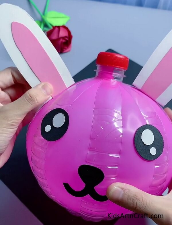 Pasting ears. tutorial of Easy Bunny Craft Using Recycled Plastic Bottles for kids