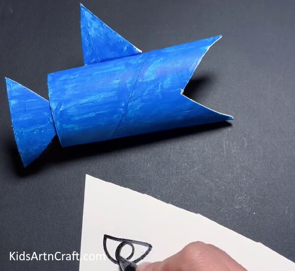 Drawing Eye On Paper - Crafting a shark project from upcycled cardboard tubing for children.