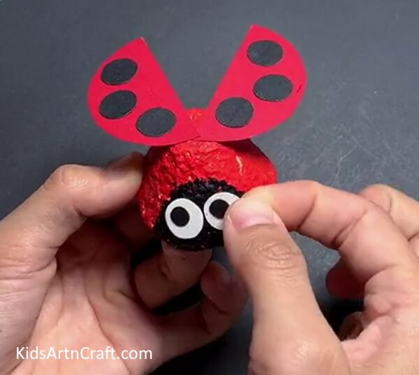 Pasting The Eyes- Fabricating a Ladybug Figurine with a Reused Egg Carton 