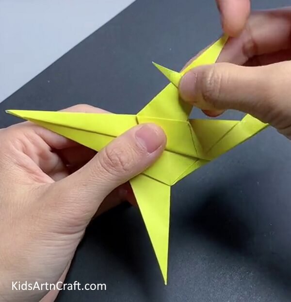 Folding Wing's Top Layer Triangle - Step-by-step instructions for creating an origami airplane 