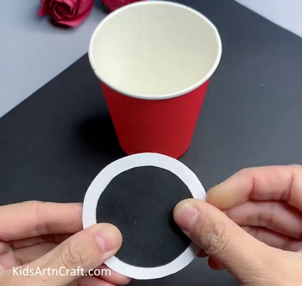 Pasting Black Circle On White Circle - Repurpose Paper Cups into a Fun Fish Project