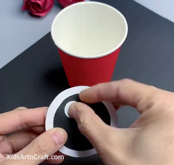 Pasting Small White Circle - How to Create a Cute Fish Craft Out of Reused Paper Cups