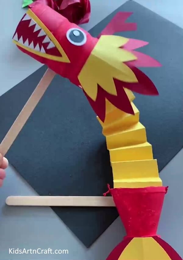 Adding Body - A child-friendly craft to make a dragon using paper and plastic containers. 