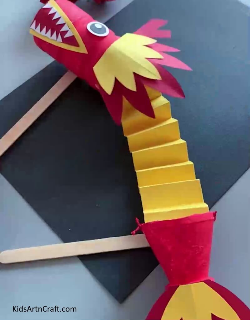 Chinese Puppet Dragon Craft Is Ready! - A straightforward and enjoyable art project for kids to create a dragon out of paper and plastic bottles. 