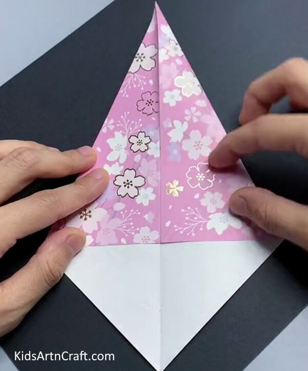Folding Corners Of The Paper To The Middle - Follow the instructions to create a paper bird.