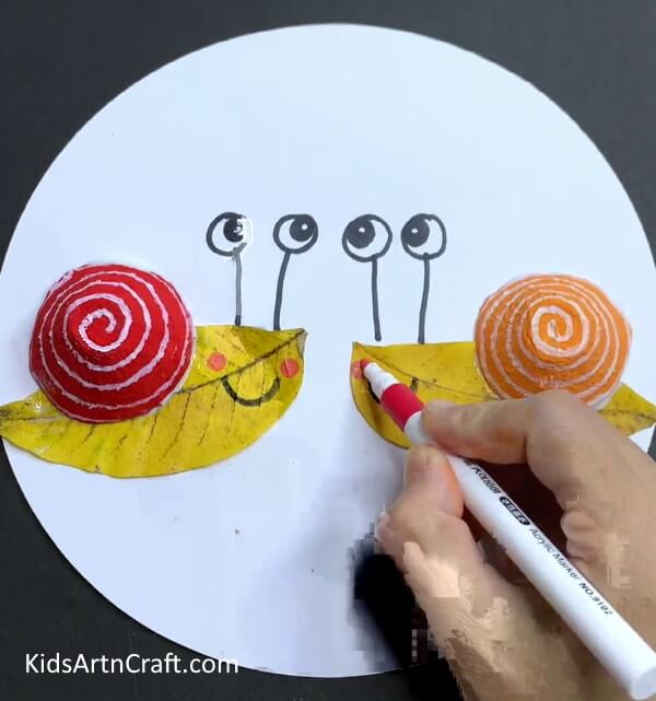 Adding Details to The Art - Step-by-Step Guide to Making a Snail with an Egg Carton and a Leaf