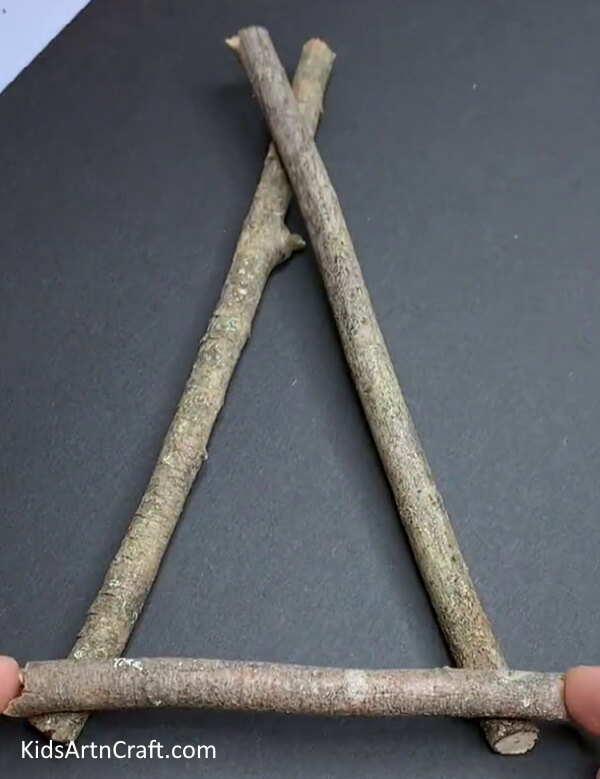 Making A Triangular Shape - A miniature swing constructed from wood is available for children to play with.