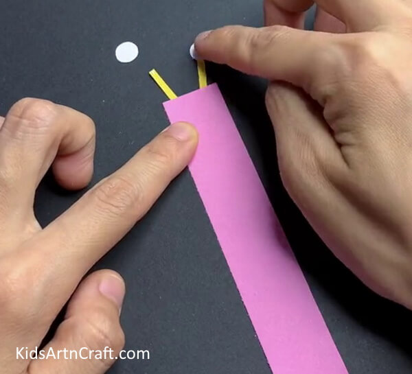 Step -4  Pasting Eyes Learn How to Make a Paper Snail Activity with Children 