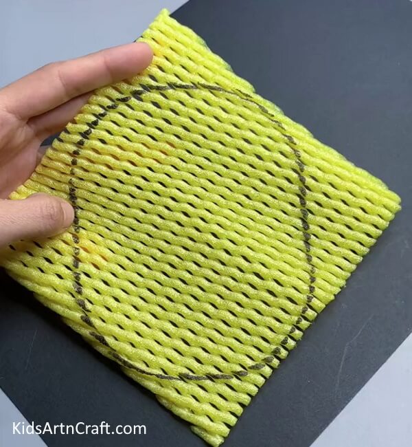 Drawing Pineapple Shape On Foam Net - Doing a Pineapple Fruit Craft Project with Foam Mesh