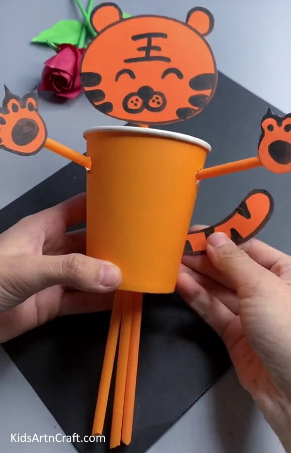 Make Paws And Tail With Orange Craft Paper-Transform Used Paper Cups into a Tiger with the Kids 